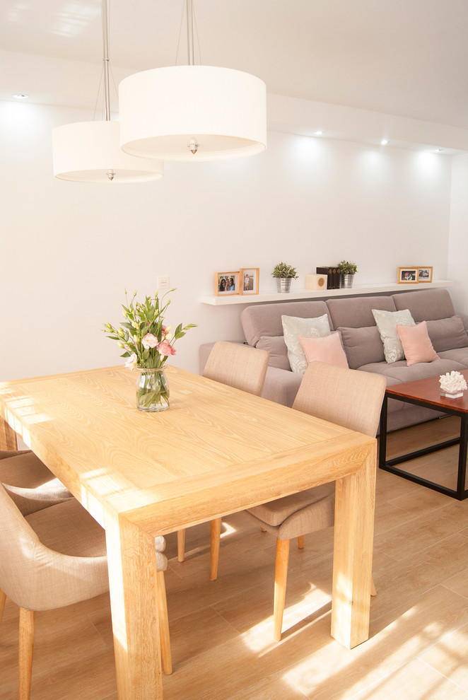Medium sized scandi open plan dining room in Malaga with white walls, light hardwood flooring and no fireplace.