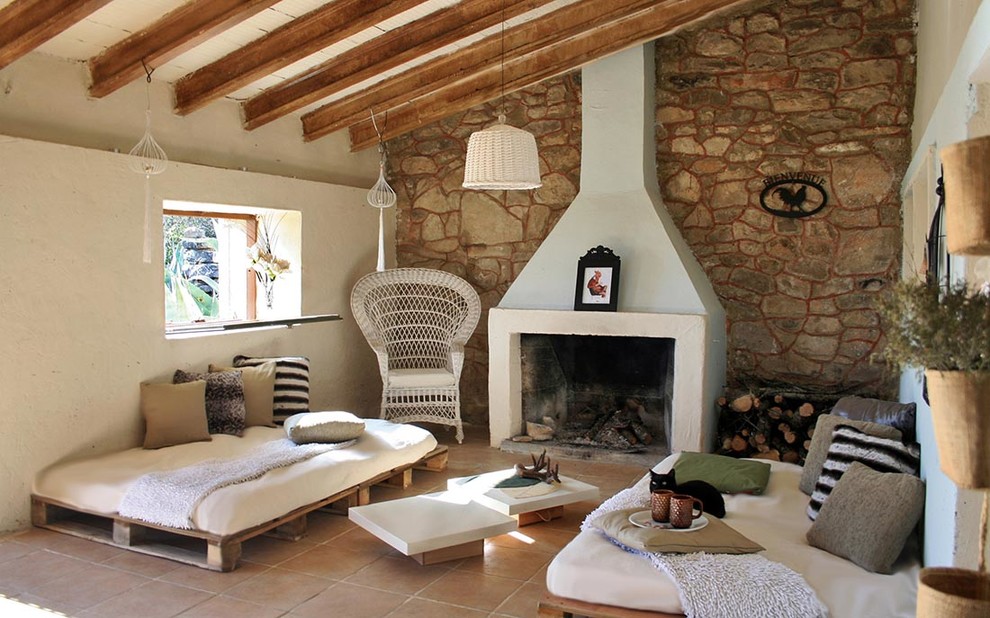 Aménagement d'une petite salle à manger ouverte sur le salon campagne avec un mur beige, un sol en carrelage de porcelaine, une cheminée standard, un manteau de cheminée en brique et un sol beige.