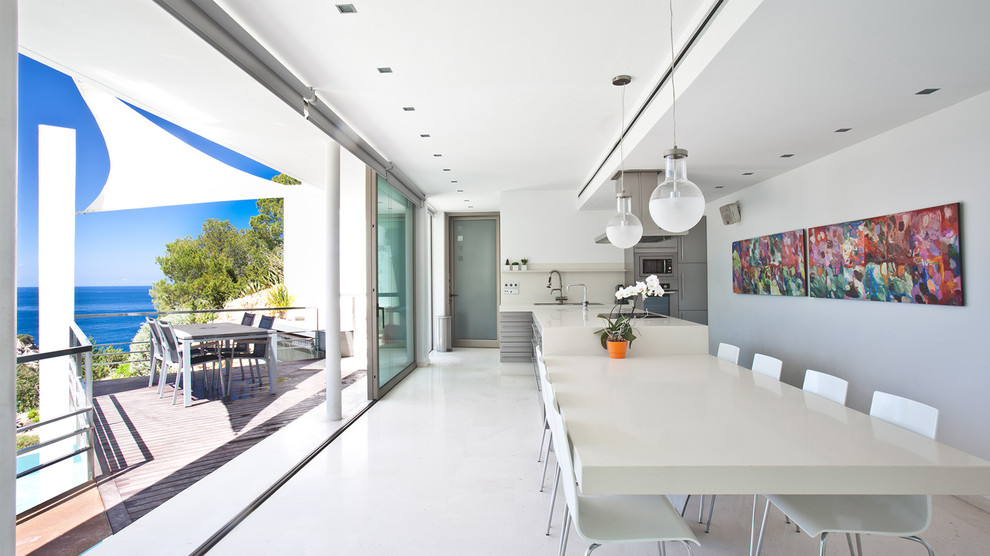 Kitchen/dining room combo - contemporary white floor kitchen/dining room combo idea in Other with white walls