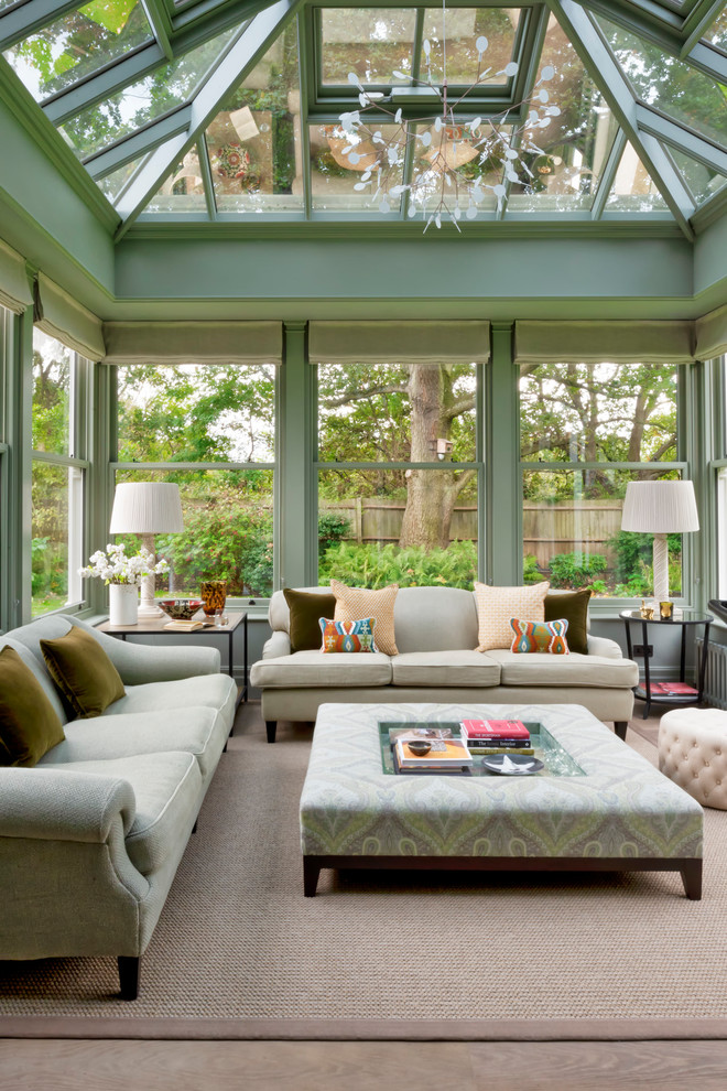 Inspiration for a classic conservatory in London with medium hardwood flooring, a glass ceiling and brown floors.