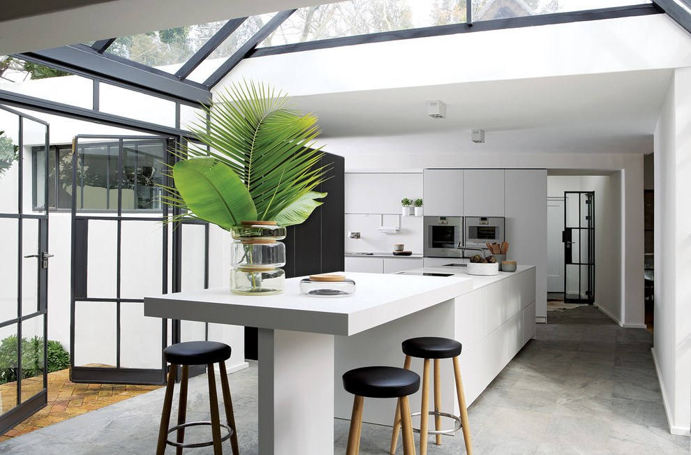 This is an example of a large contemporary conservatory in Other with marble flooring, grey floors and a glass ceiling.