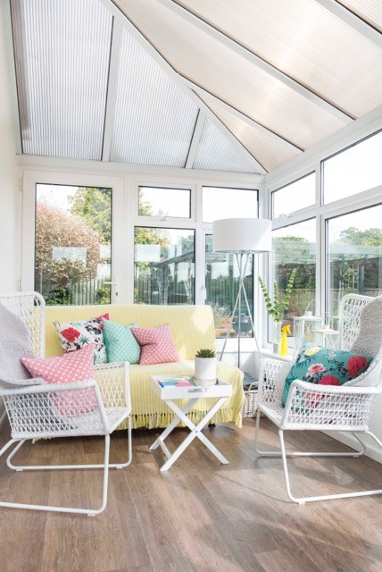 Design ideas for a medium sized contemporary conservatory in Devon with laminate floors and brown floors.