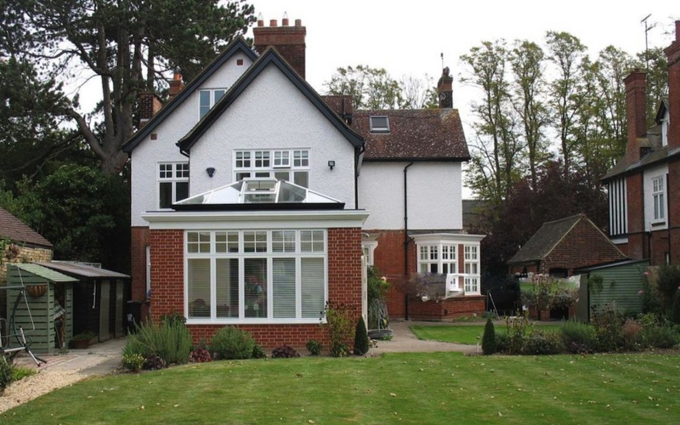 Medium sized traditional conservatory in Cambridgeshire with ceramic flooring, a glass ceiling and beige floors.