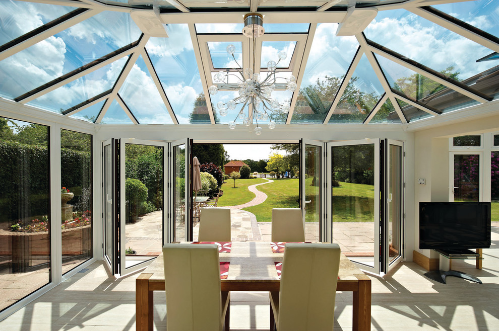 Photo of a traditional conservatory in Essex with light hardwood flooring, a glass ceiling and beige floors.