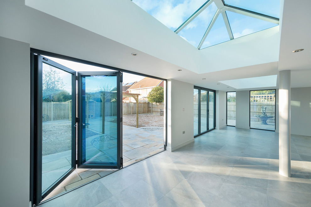 Foto di una grande veranda contemporanea con pavimento con piastrelle in ceramica e soffitto in vetro
