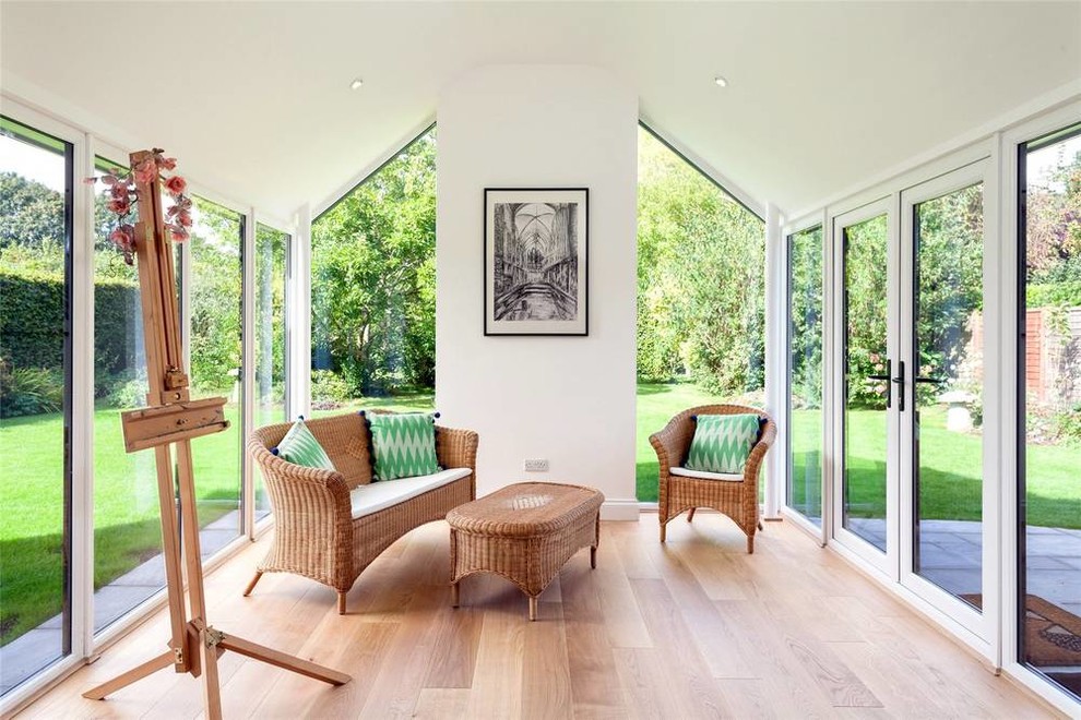 Medium sized contemporary conservatory in Sussex with beige floors and medium hardwood flooring.