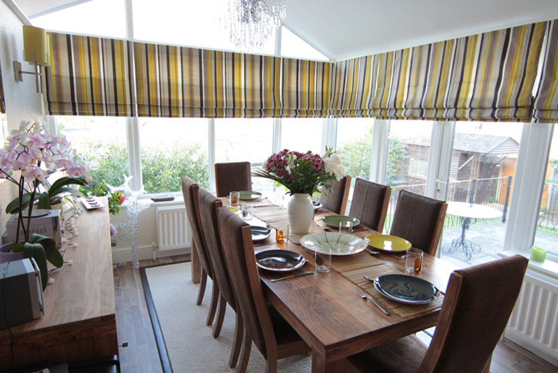Large trendy laminate floor dining room photo in Hertfordshire with no fireplace and a plaster fireplace