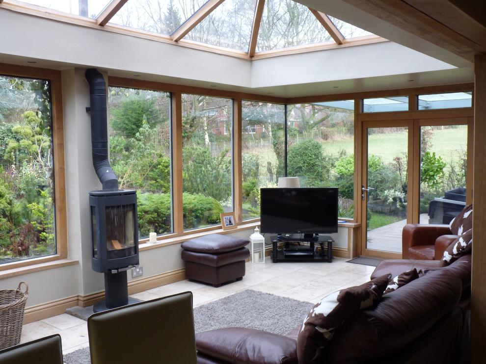 Photo of a large contemporary conservatory in Other with a hanging fireplace and a glass ceiling.
