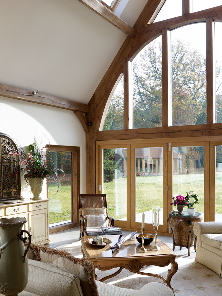 Traditional conservatory in Surrey with a skylight and beige floors.