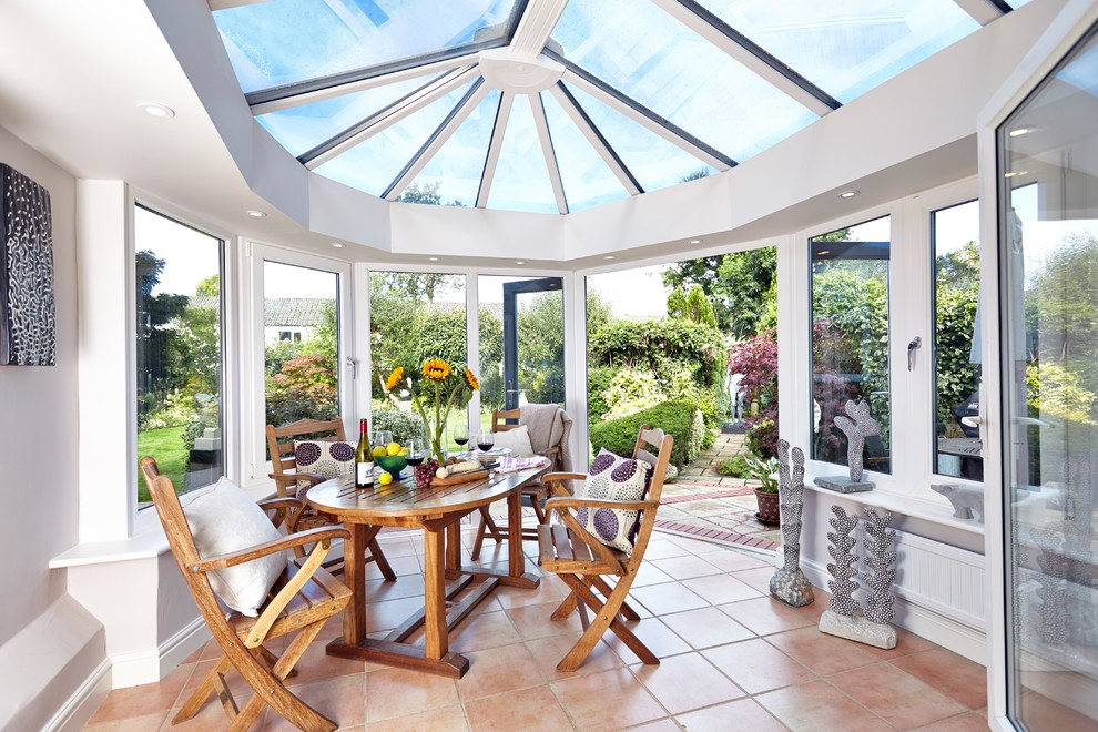 Design ideas for a mediterranean conservatory in Berkshire with terracotta flooring, a glass ceiling and red floors.