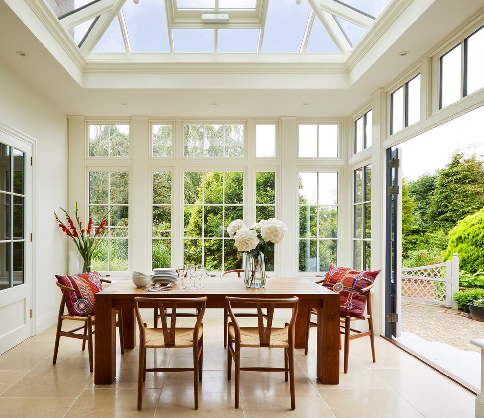 This is an example of a medium sized traditional conservatory in Essex with marble flooring, beige floors and a glass ceiling.