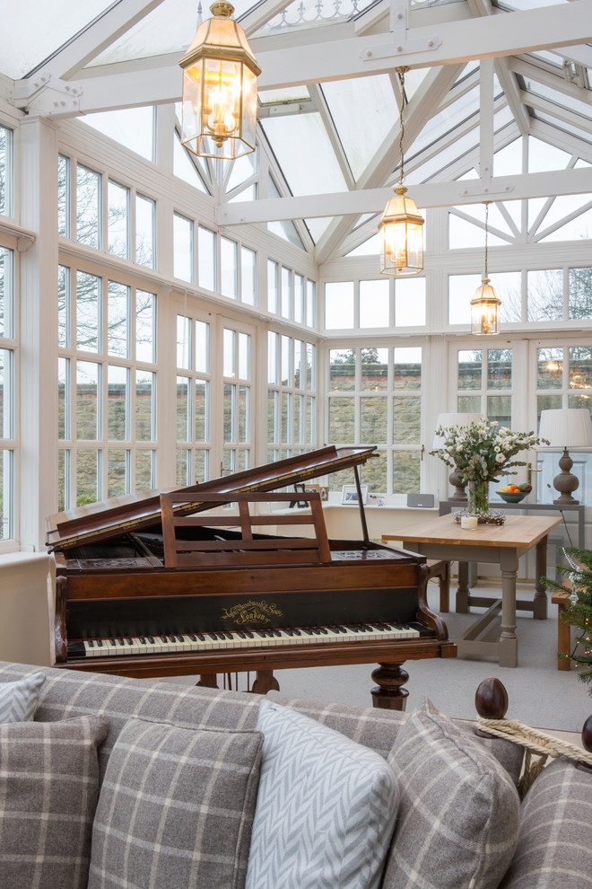 This is an example of a classic conservatory in Oxfordshire with carpet, a glass ceiling and grey floors.