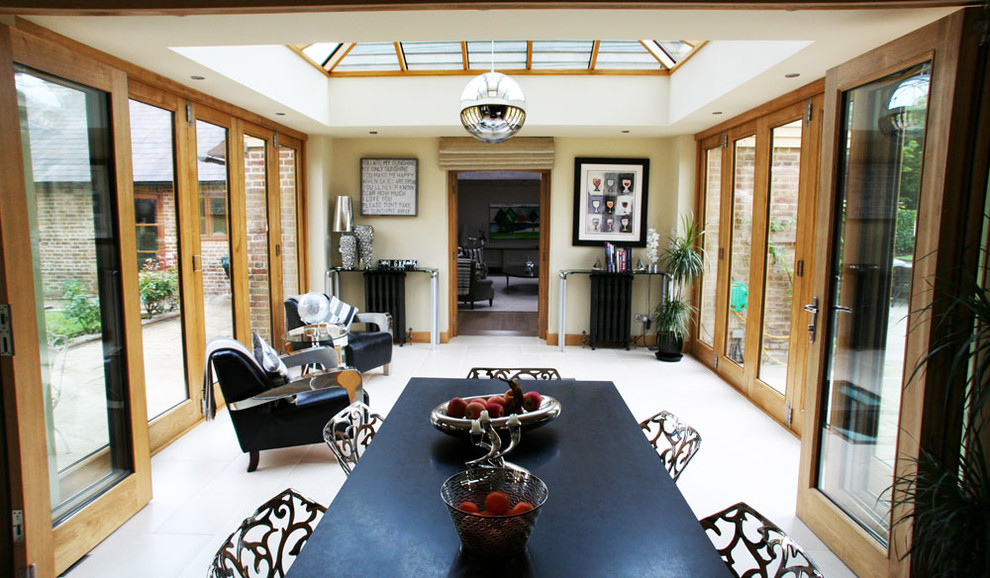 Photo of a medium sized modern conservatory in Sussex with a glass ceiling.