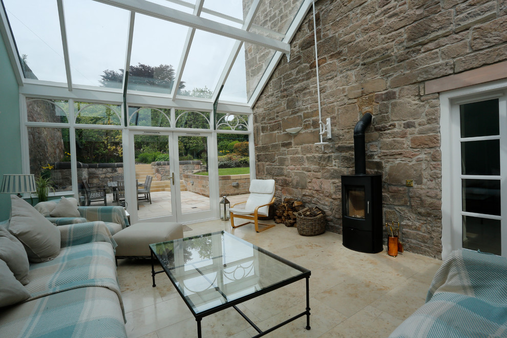 Design ideas for a large classic conservatory in Glasgow with travertine flooring, a wood burning stove, a metal fireplace surround and a glass ceiling.