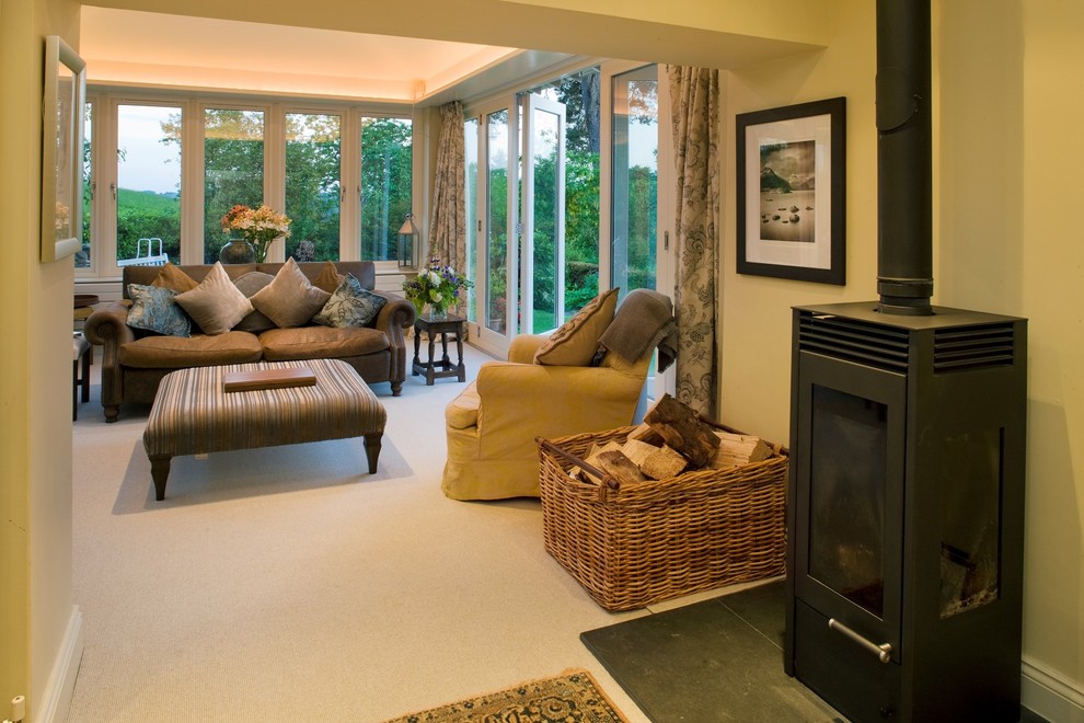 Photo of a small traditional conservatory in Other with carpet, a skylight and grey floors.