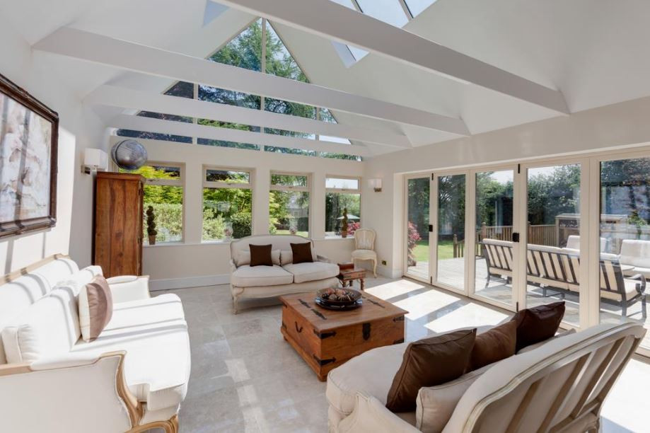 Example of a mid-sized classic porcelain tile and beige floor sunroom design in Other with a skylight