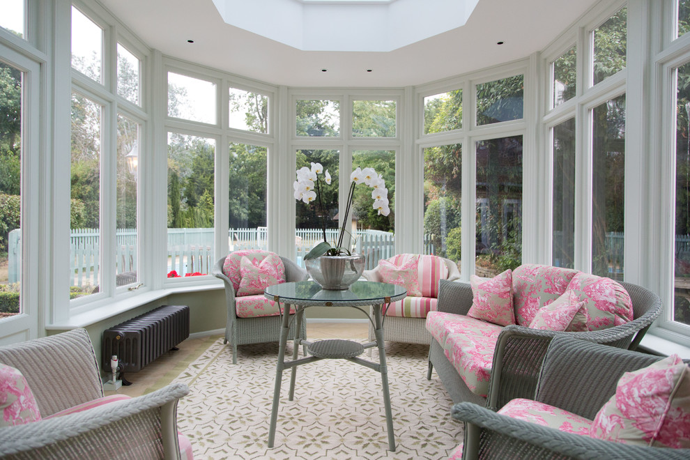 This is an example of a medium sized traditional conservatory in London with no fireplace and a skylight.