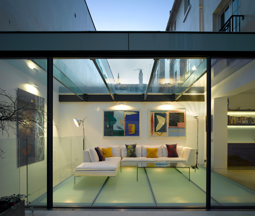 Photo of a contemporary conservatory in London with no fireplace and a glass ceiling.