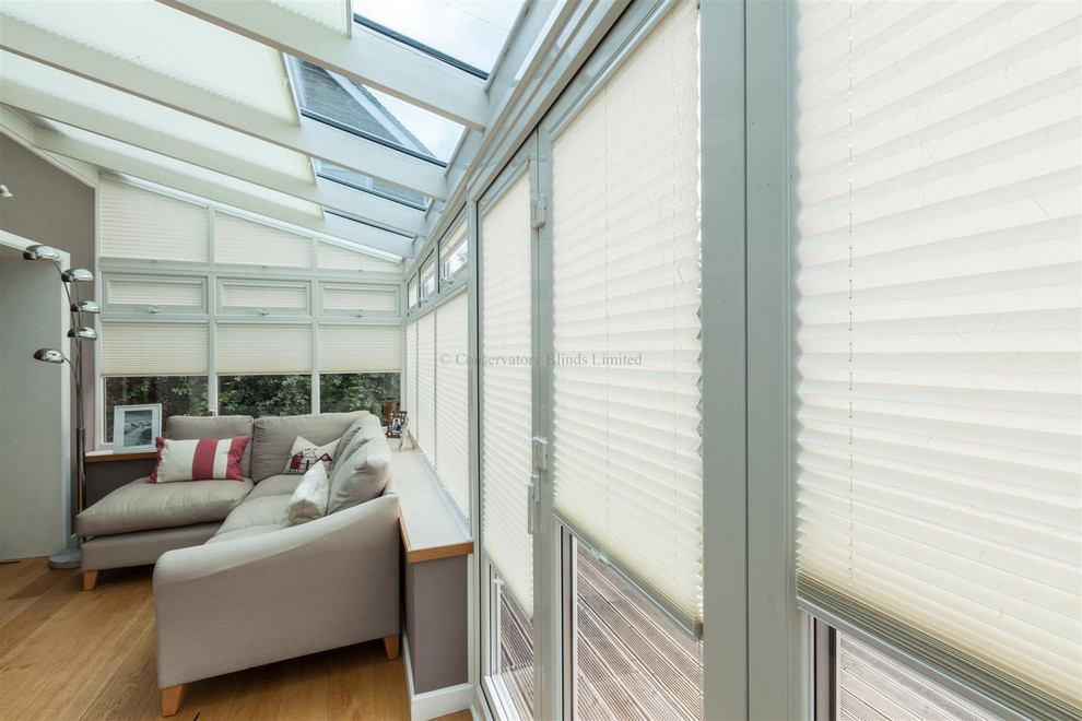 This is an example of a medium sized contemporary conservatory in Surrey.