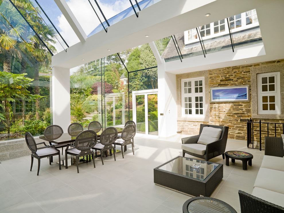 Inspiration for a large contemporary conservatory in Cornwall with limestone flooring, a glass ceiling and beige floors.