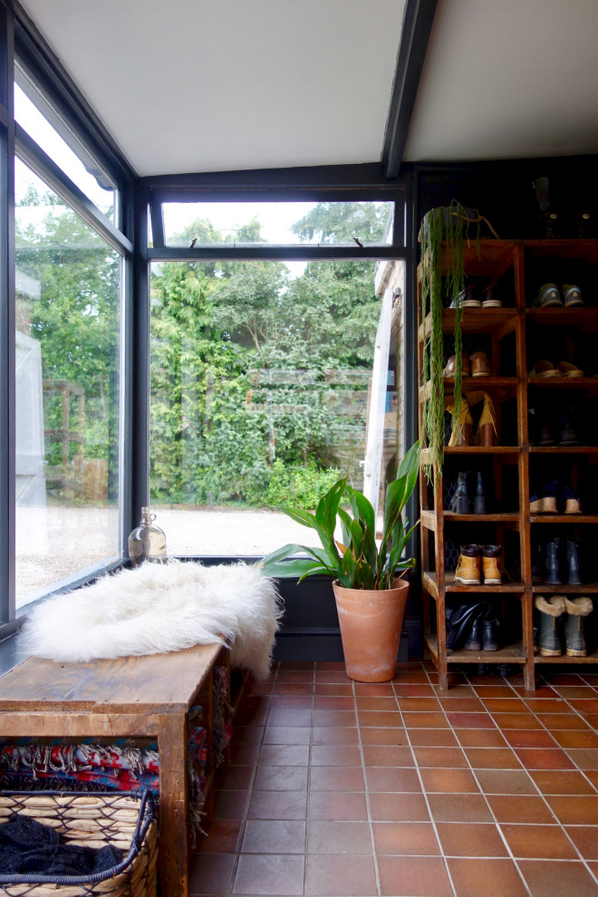 Photo of a medium sized rustic conservatory in Other with terracotta flooring, no fireplace, a standard ceiling and red floors.