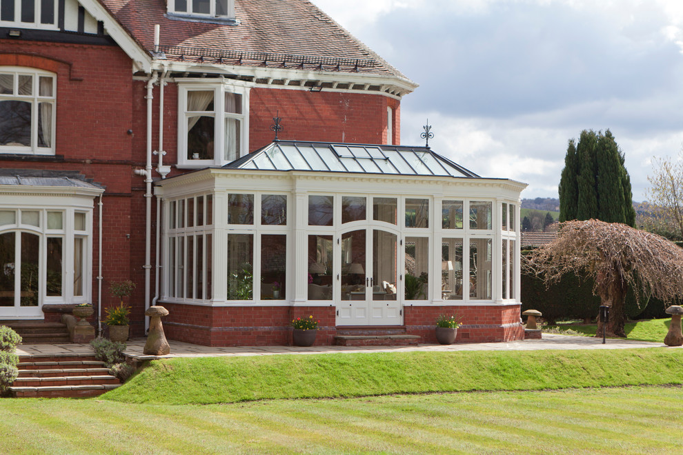Large traditional conservatory in Other with limestone flooring, no fireplace and a glass ceiling.