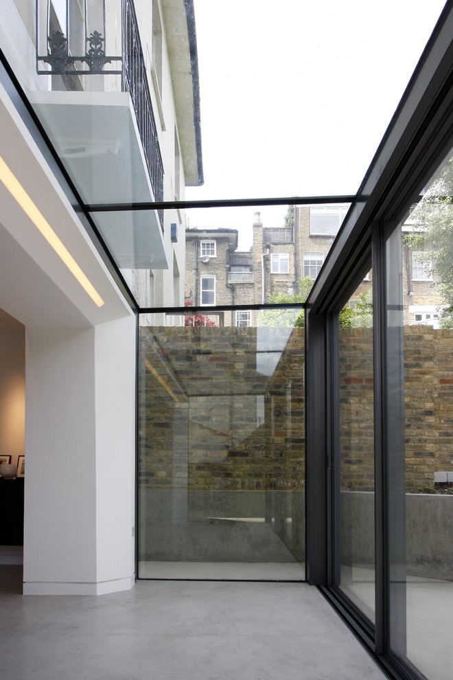 Design ideas for a small contemporary conservatory in London with a glass ceiling and concrete flooring.