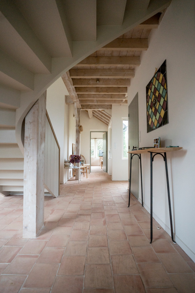 Inspiration for a coastal beige floor hallway remodel in Rennes with white walls