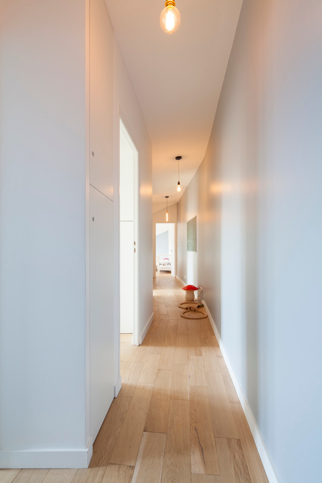Hallway - large contemporary hallway idea in Paris with white walls