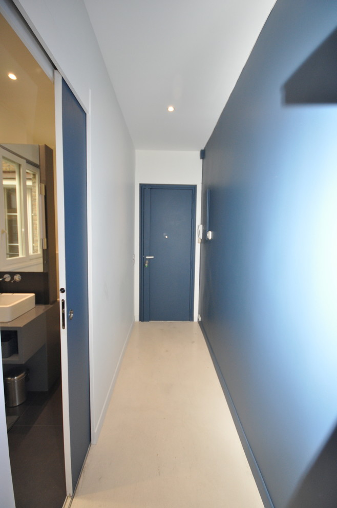Example of a mid-sized trendy vinyl floor and beige floor hallway design in Lyon with blue walls