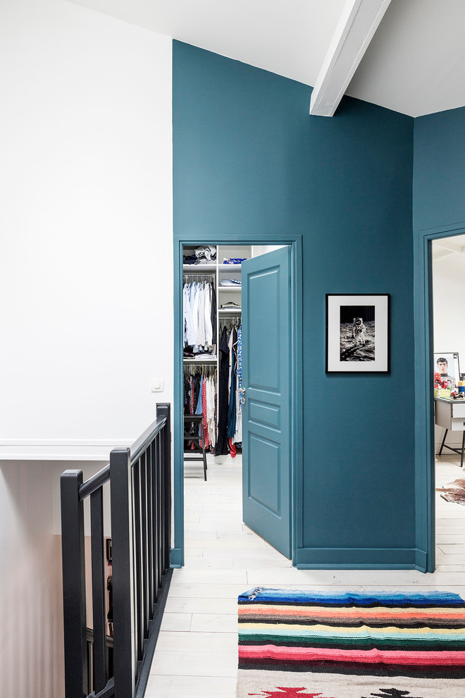 Стильный дизайн: коридор в стиле модернизм с синими стенами и деревянным полом - последний тренд