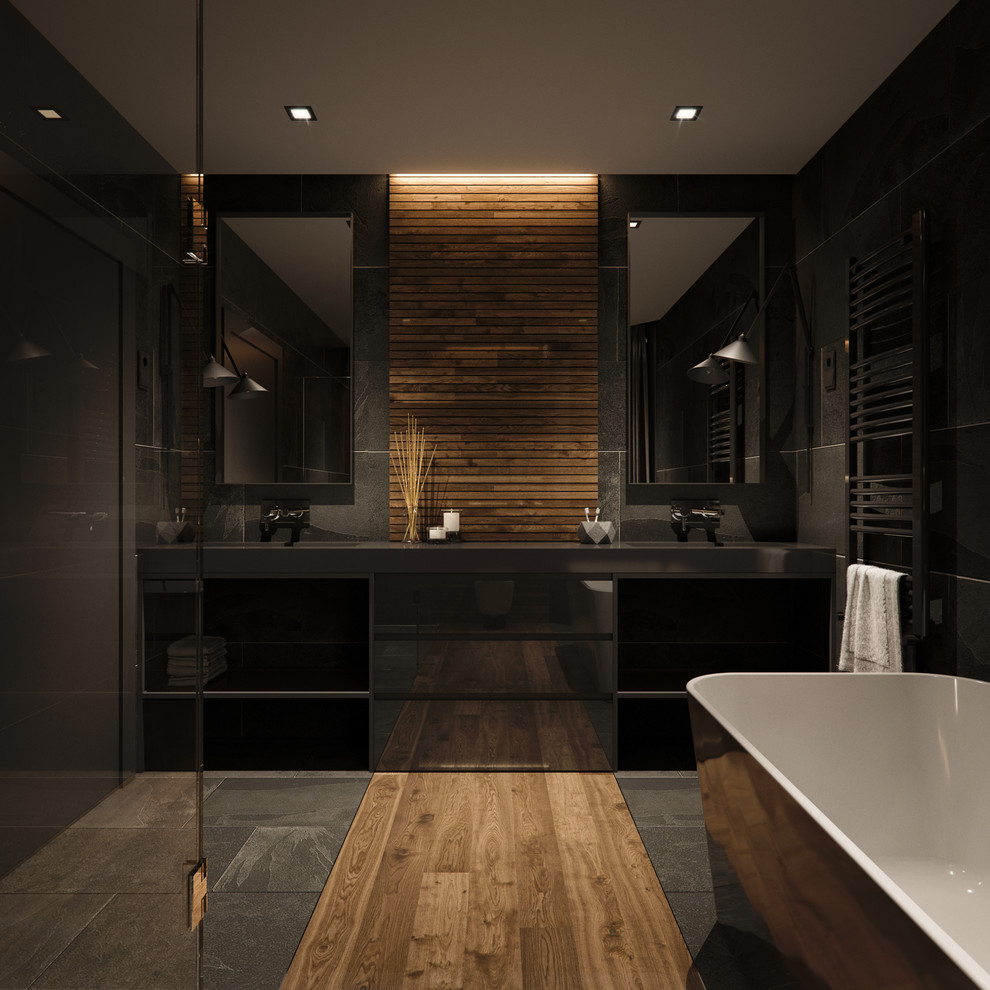 Ejemplo de cuarto de baño principal industrial con bañera exenta, ducha a ras de suelo, paredes negras, suelo negro y encimeras negras