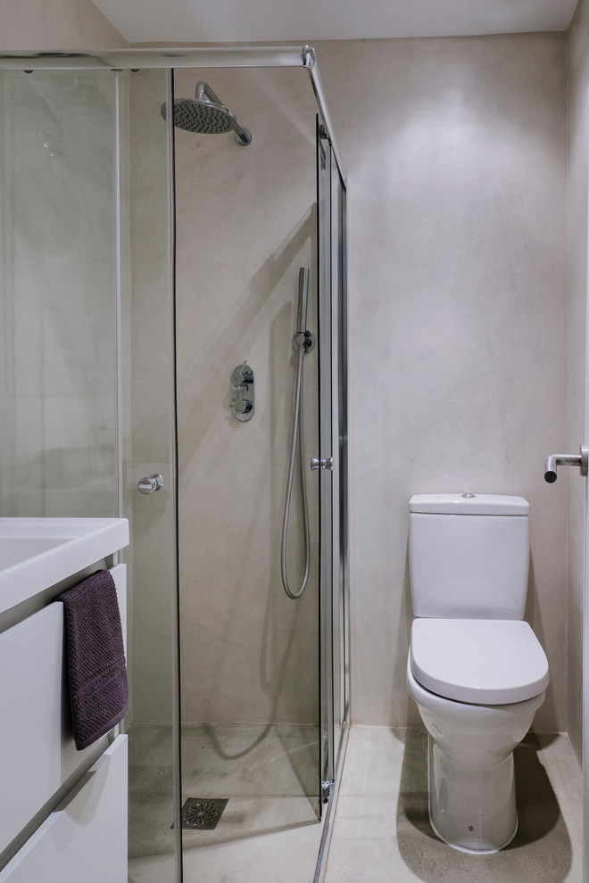 Idee per una stanza da bagno con doccia nordica di medie dimensioni con ante lisce, ante bianche, doccia ad angolo, WC a due pezzi, pareti grigie, pavimento in cemento e lavabo rettangolare