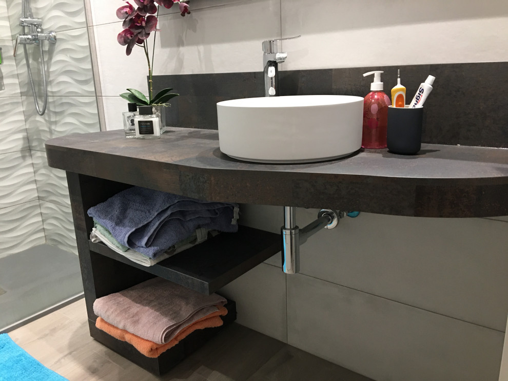 This is an example of a medium sized industrial ensuite bathroom in Other with open cabinets, white cabinets, a built-in shower, beige tiles, ceramic tiles, laminate floors, a vessel sink, laminate worktops, brown floors and multi-coloured worktops.