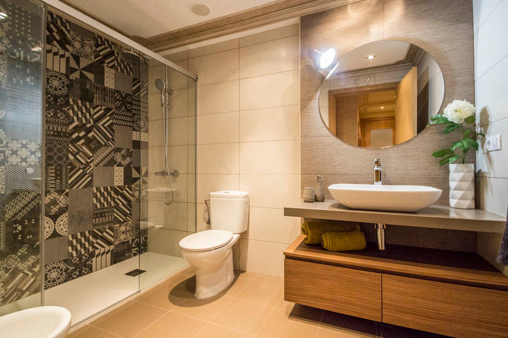 Photo of a medium sized contemporary shower room bathroom in Other with a vessel sink, flat-panel cabinets, an alcove shower, a two-piece toilet, grey tiles, medium wood cabinets, beige walls, ceramic flooring, engineered stone worktops and grey worktops.