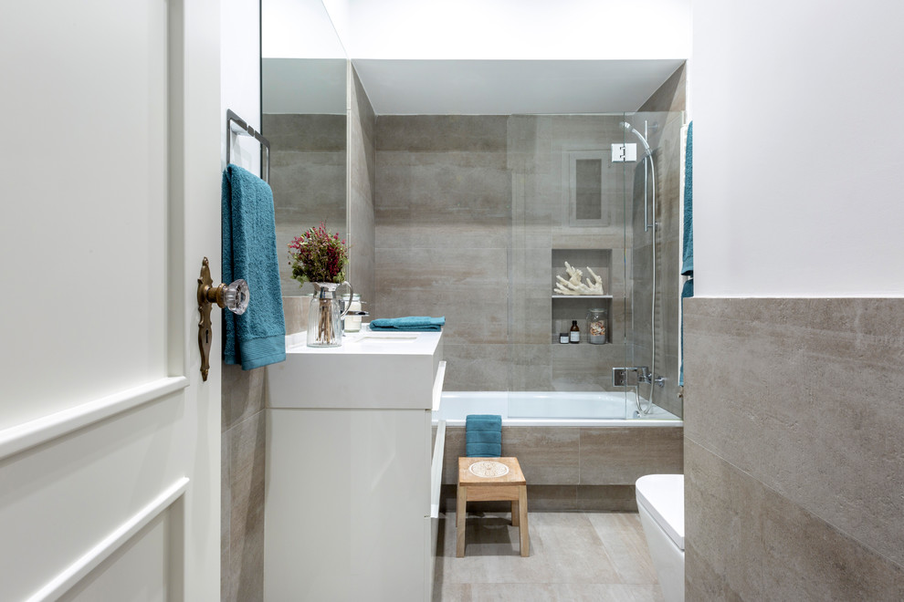 Inspiration pour une petite salle de bain design pour enfant avec une baignoire en alcôve, WC suspendus, un carrelage gris, des carreaux de béton, un mur blanc, carreaux de ciment au sol, un lavabo encastré, un plan de toilette en quartz modifié, un sol gris, une cabine de douche à porte coulissante et un plan de toilette blanc.