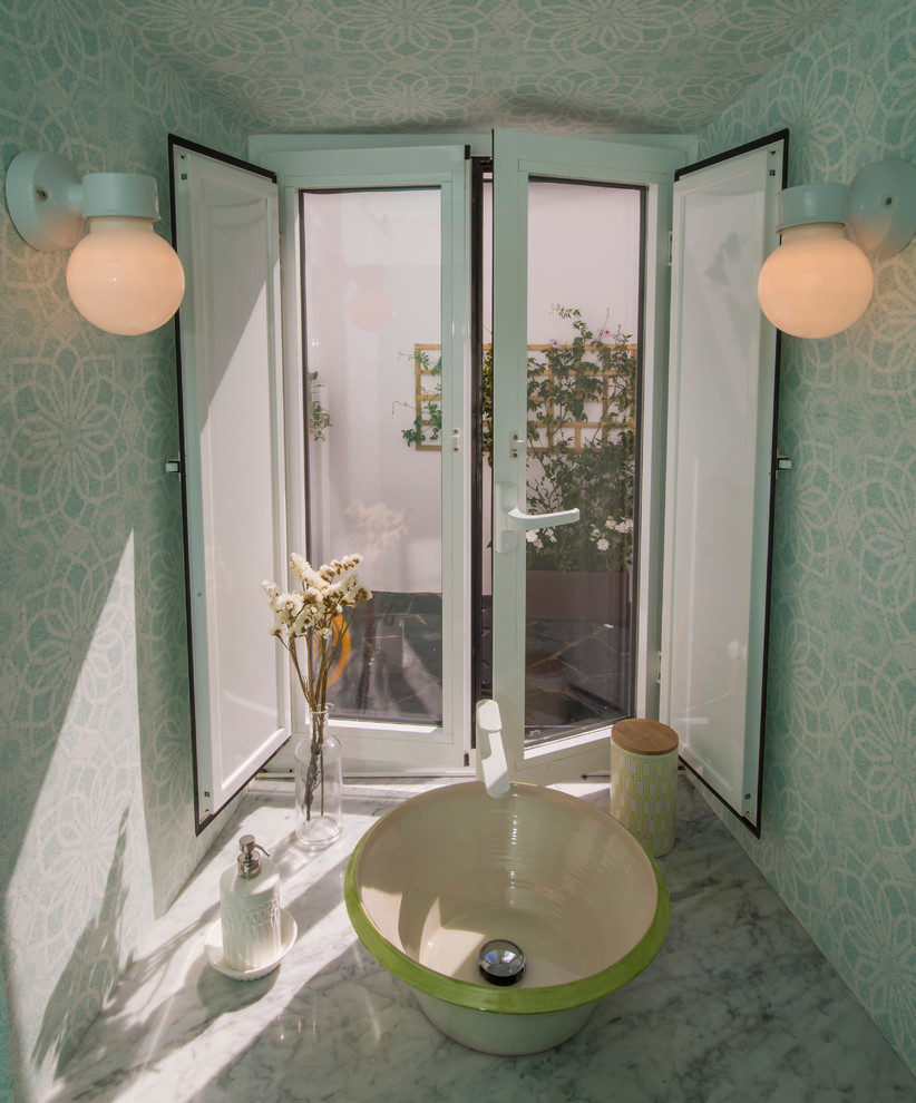 Bathroom - small mid-century modern 3/4 green tile and ceramic tile light wood floor and gray floor bathroom idea in Madrid with recessed-panel cabinets, green cabinets, a one-piece toilet, multicolored walls, a vessel sink and marble countertops