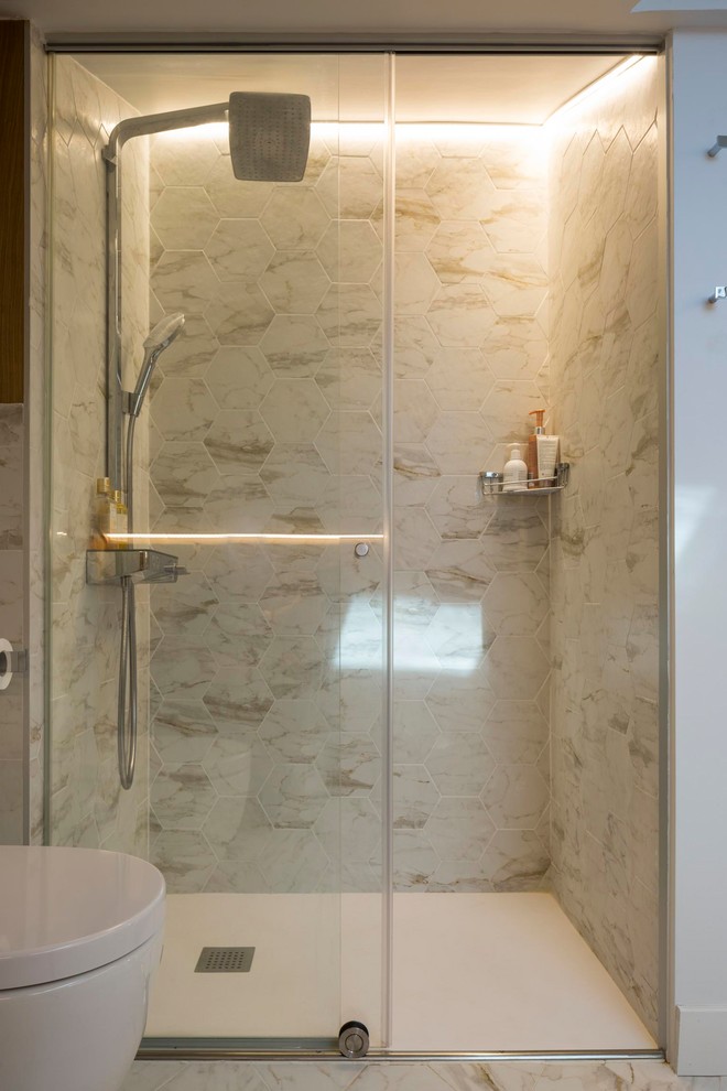 Contemporary shower room bathroom in Other with porcelain tiles, a corner shower, a wall mounted toilet, grey tiles, brown walls and grey floors.