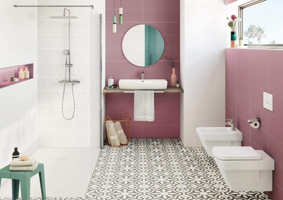 Cette photo montre une salle de bain tendance avec des portes de placard beiges, une douche à l'italienne, WC suspendus, un carrelage rose, un mur rose, une vasque, aucune cabine et un plan de toilette beige.