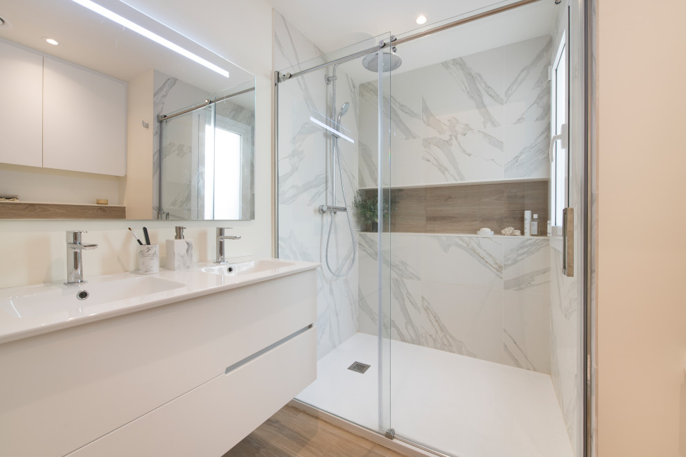 Medium sized scandi ensuite bathroom in Other with flat-panel cabinets, white cabinets, an alcove shower, a wall mounted toilet, white tiles, porcelain tiles, white walls, porcelain flooring, a submerged sink, engineered stone worktops, brown floors, a sliding door, white worktops, a wall niche, double sinks and a floating vanity unit.