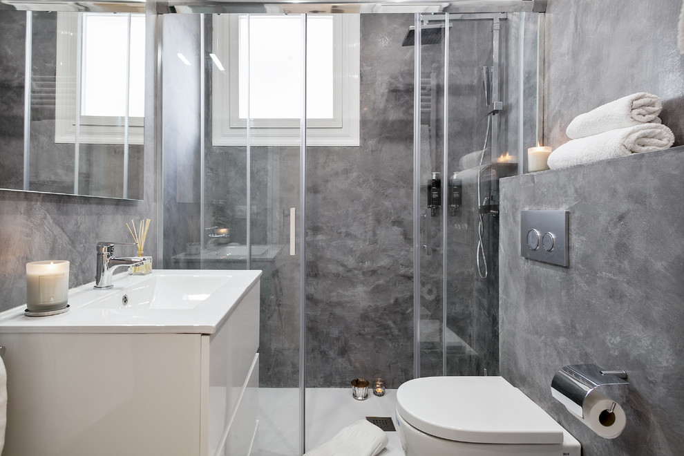 Inspiration for a medium sized contemporary shower room bathroom in Other with flat-panel cabinets, white cabinets, a one-piece toilet, grey walls and an integrated sink.