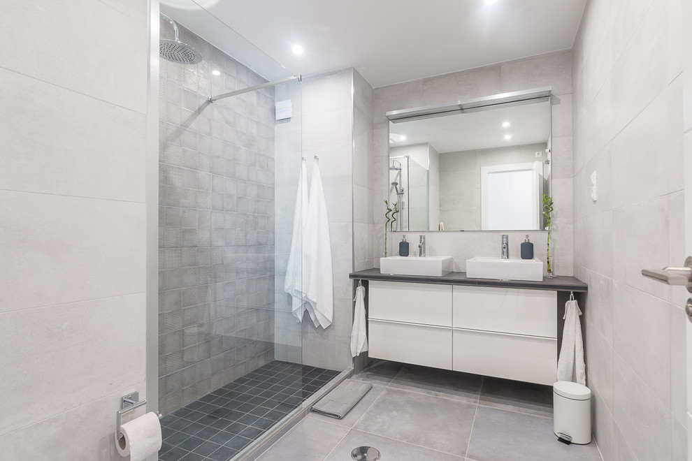 Idéer för stora medelhavsstil en-suite badrum, med möbel-liknande, vita skåp, en öppen dusch, grå kakel, keramikplattor, grå väggar, klinkergolv i porslin, ett fristående handfat, granitbänkskiva och grått golv