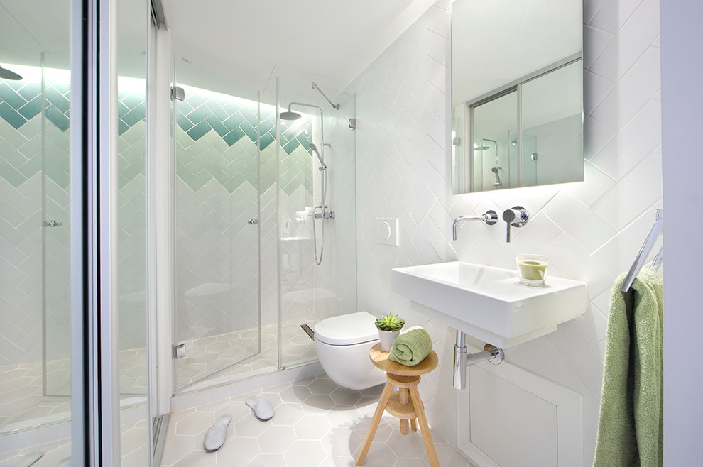 Ejemplo de cuarto de baño principal actual de tamaño medio con ducha empotrada, sanitario de pared, baldosas y/o azulejos de cerámica, paredes blancas y lavabo suspendido