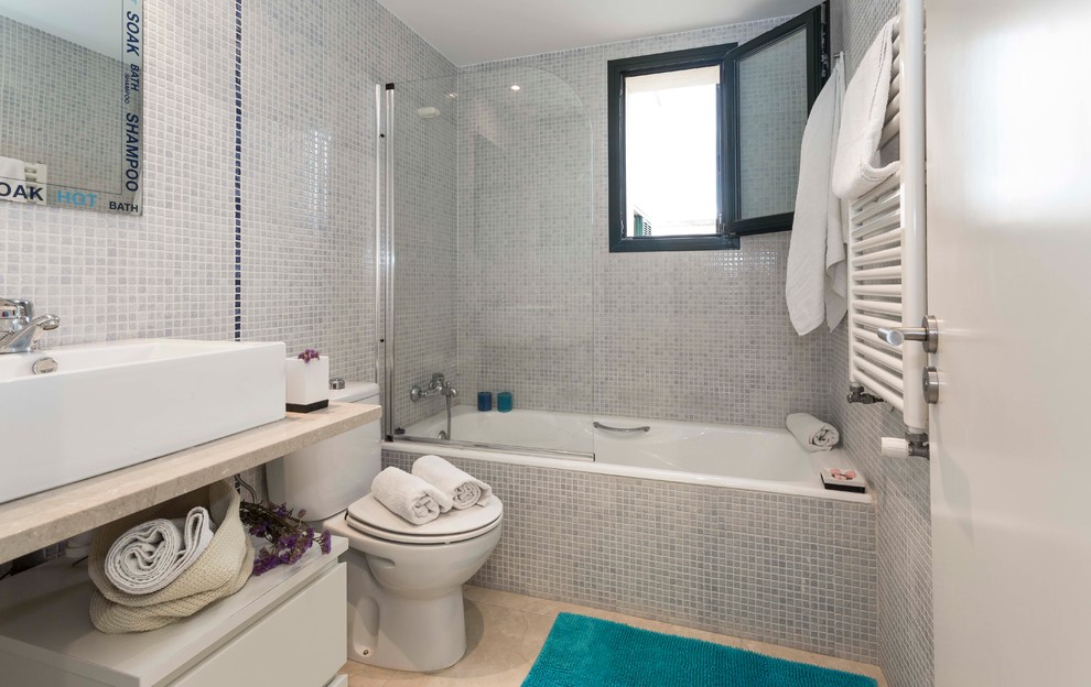 Immagine di una piccola stanza da bagno con doccia tradizionale con consolle stile comò, ante bianche, vasca ad alcova, vasca/doccia, WC a due pezzi, lavabo a bacinella e top in marmo
