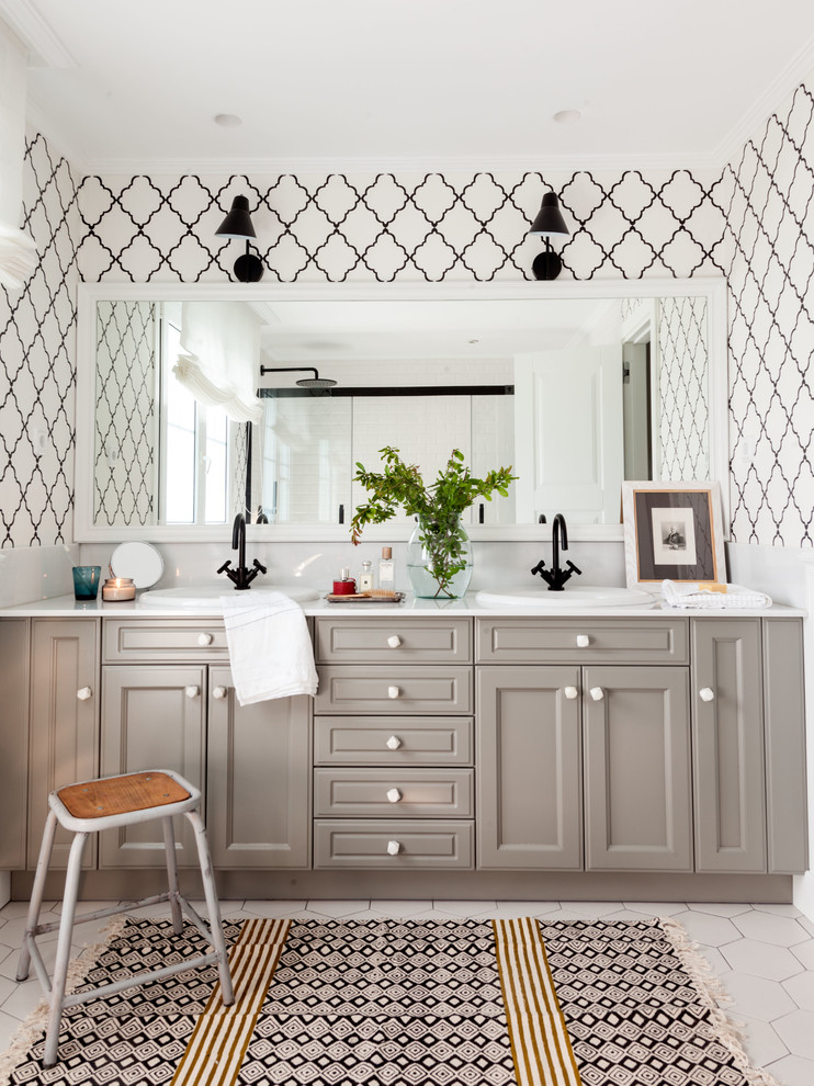 Bathroom - transitional white floor bathroom idea in Bilbao with beaded inset cabinets, gray cabinets, white walls, a drop-in sink and white countertops
