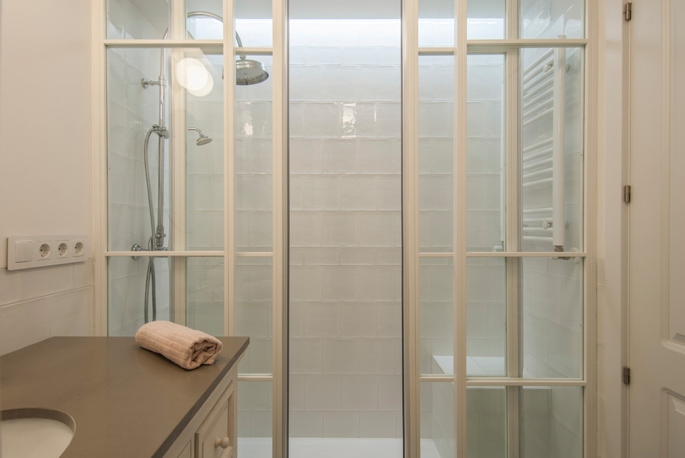 Idéer för att renovera ett litet shabby chic-inspirerat grå grått en-suite badrum, med luckor med lamellpanel, vita skåp, en kantlös dusch, vit kakel, keramikplattor, vita väggar, klinkergolv i keramik, ett undermonterad handfat, bänkskiva i betong, grått golv och dusch med skjutdörr