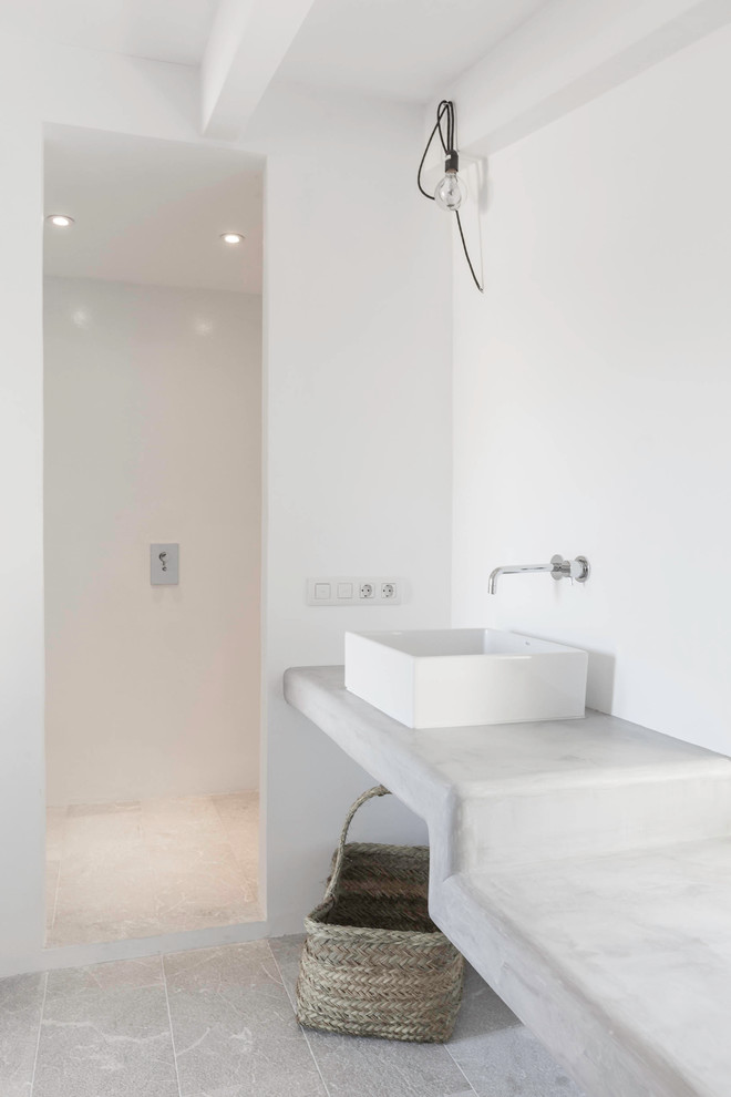 Photo of a medium sized mediterranean shower room bathroom in Palma de Mallorca with a walk-in shower, grey walls, a vessel sink and concrete worktops.