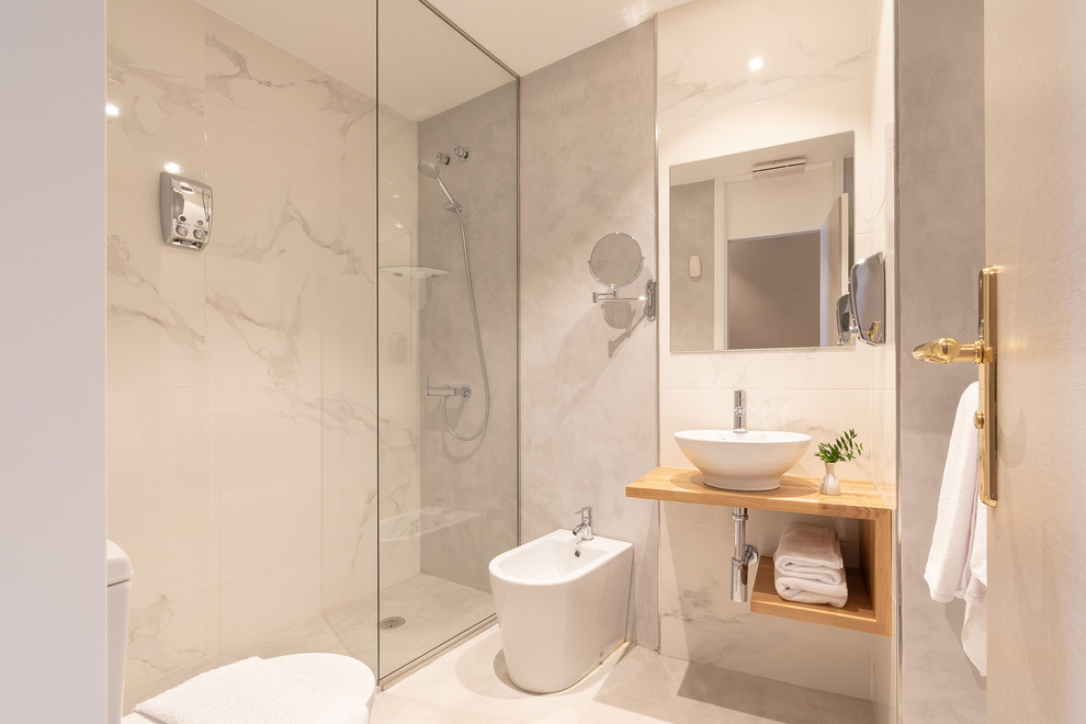 Photo of an expansive contemporary shower room bathroom in Other with open cabinets, medium wood cabinets, a built-in shower, a bidet, white tiles, white walls, a vessel sink, wooden worktops, white floors, an open shower and brown worktops.