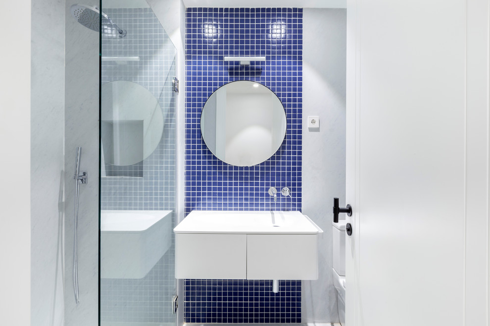 Small trendy 3/4 blue tile and mosaic tile bathroom photo in Other with flat-panel cabinets, white cabinets, an integrated sink and white countertops
