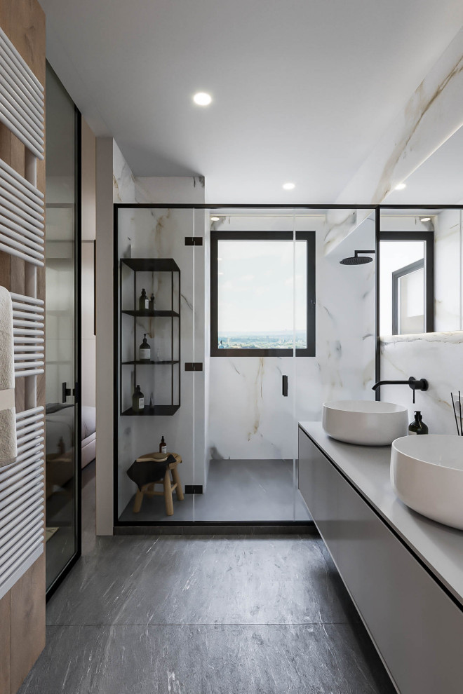 Medium sized modern wet room bathroom in Valencia with open cabinets, white cabinets, a wall mounted toilet, multi-coloured tiles, porcelain tiles, multi-coloured walls, porcelain flooring, a vessel sink, grey floors, a sliding door, double sinks, a floating vanity unit and grey worktops.